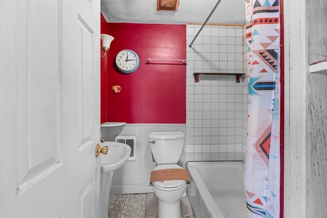 49 Boathouse Rd, Groton, MA 01450 - bathroom with toilet, tile patterned floors, shower / bath combo, and a wainscoted wall