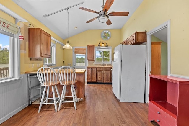 49 Boathouse Rd, Groton, MA 01450 - kitchen featuring freestanding refrigerator, a peninsula, light wood-style flooring, light countertops, and brown cabinets