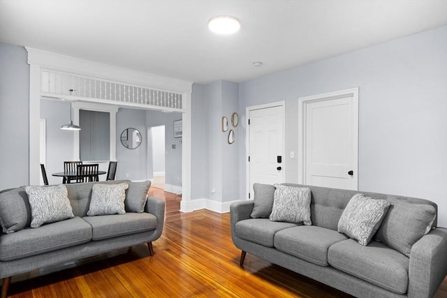 living area with wood finished floors and baseboards
