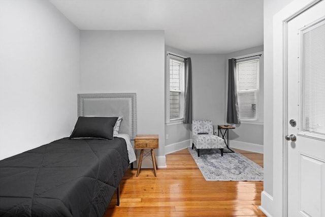 bedroom featuring light wood-style floors and baseboards