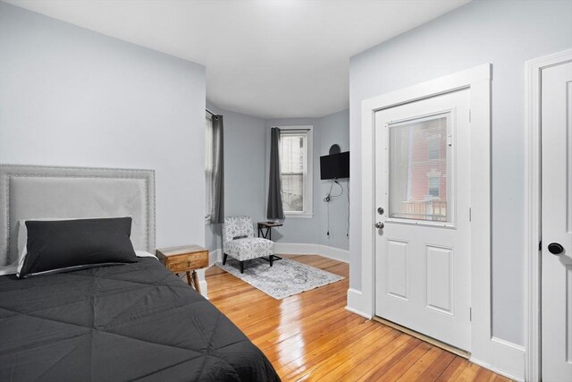 bedroom with light wood-style floors and baseboards