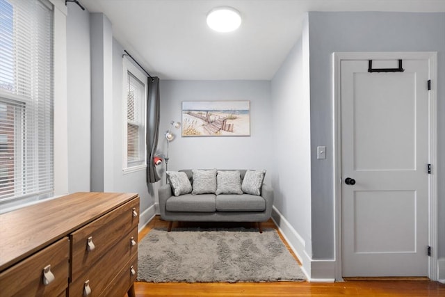 sitting room featuring baseboards and wood finished floors