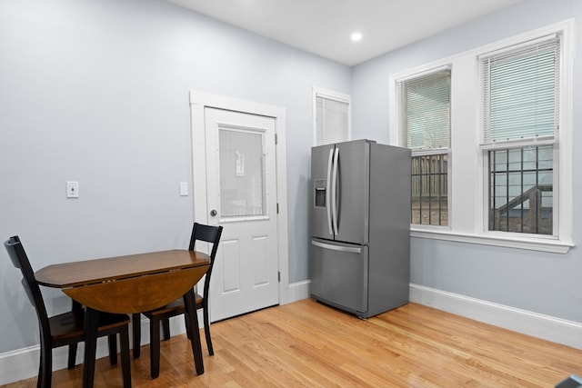 kitchen with light hardwood / wood-style floors and stainless steel fridge