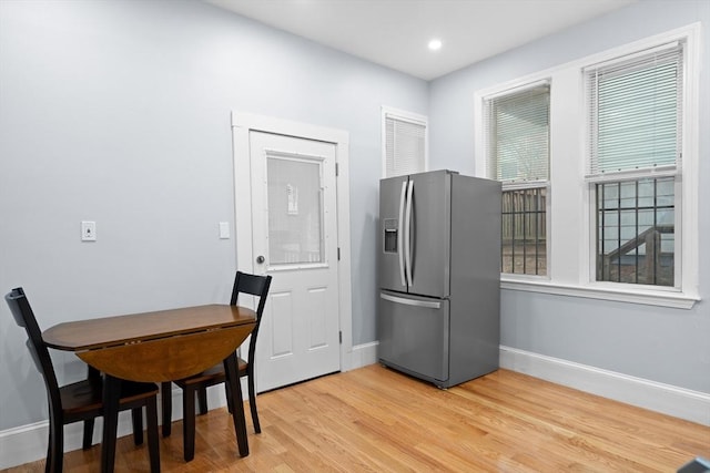 dining area with baseboards, light wood-type flooring, and recessed lighting