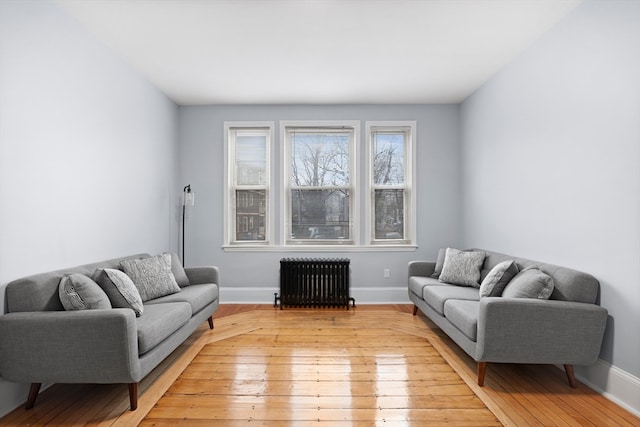 living room featuring radiator heating unit and light wood-type flooring