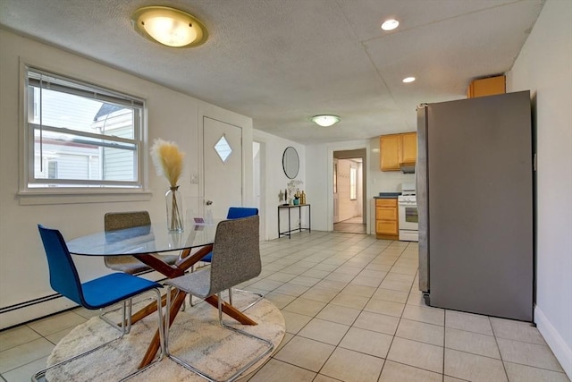 dining room featuring recessed lighting, light tile patterned floors, baseboards, a textured ceiling, and a baseboard radiator