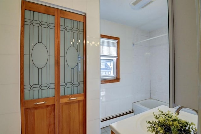 full bathroom with walk in shower, visible vents, a bathing tub, and a baseboard radiator