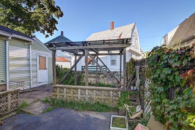exterior space featuring a pergola and a chimney