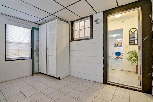 unfurnished room featuring light tile patterned flooring and a healthy amount of sunlight