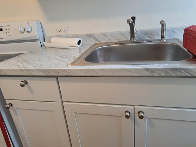 details featuring sink and white cabinets