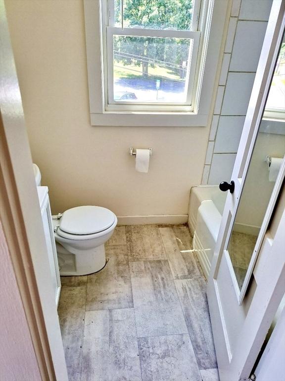 bathroom featuring a bath and toilet