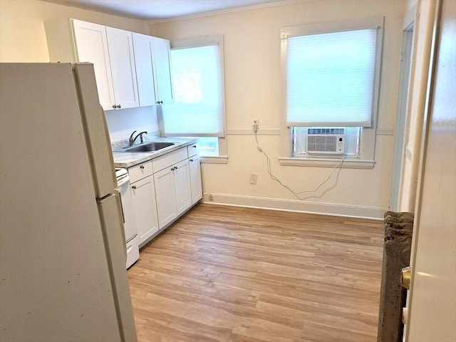 kitchen featuring sink, cooling unit, white cabinets, and white appliances