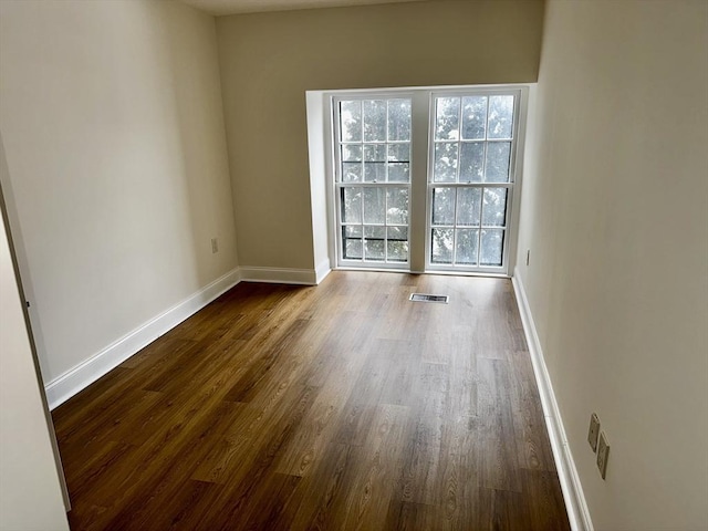 spare room featuring dark hardwood / wood-style floors