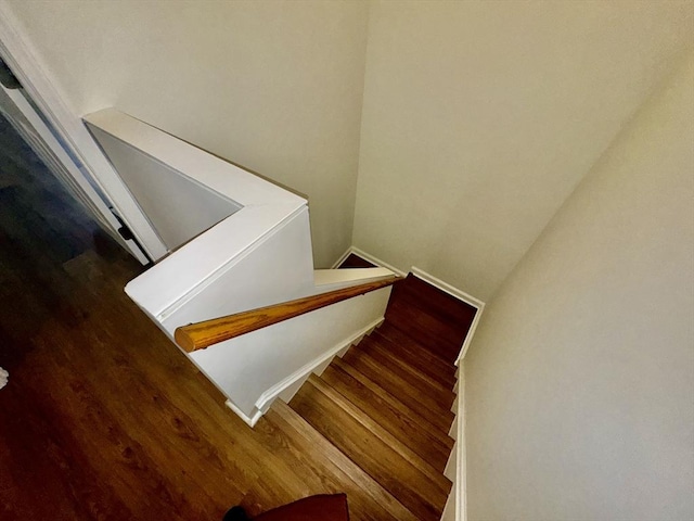 stairs featuring hardwood / wood-style floors