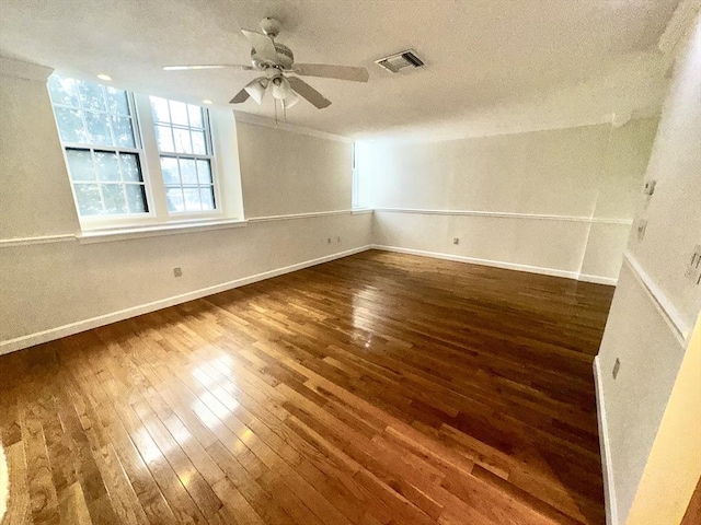 unfurnished room with ceiling fan, dark hardwood / wood-style floors, and a textured ceiling