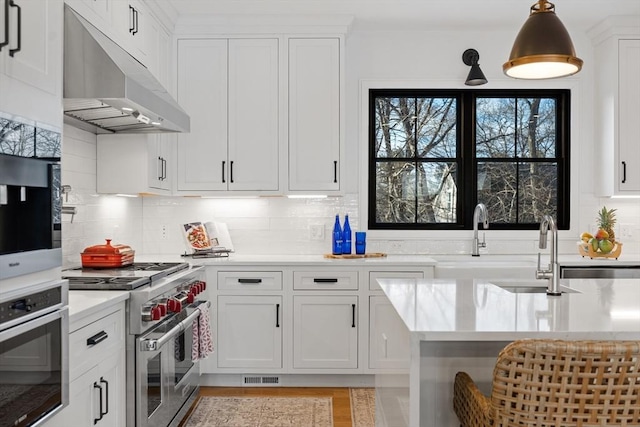 kitchen featuring white cabinetry, backsplash, and appliances with stainless steel finishes