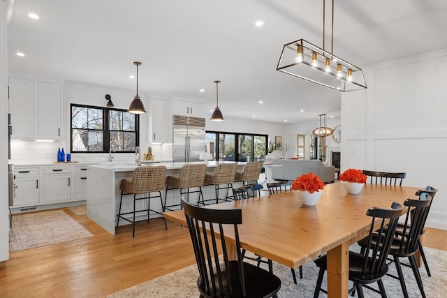 dining area with light hardwood / wood-style floors and sink