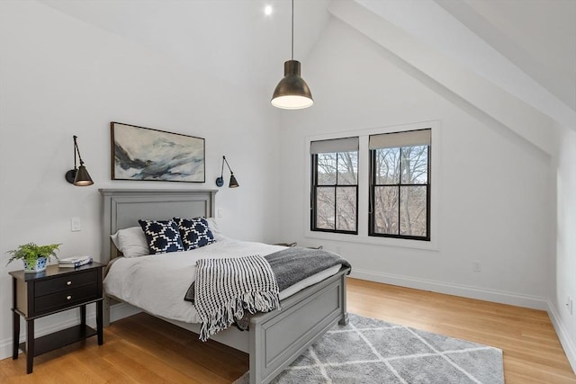 bedroom with lofted ceiling and hardwood / wood-style floors