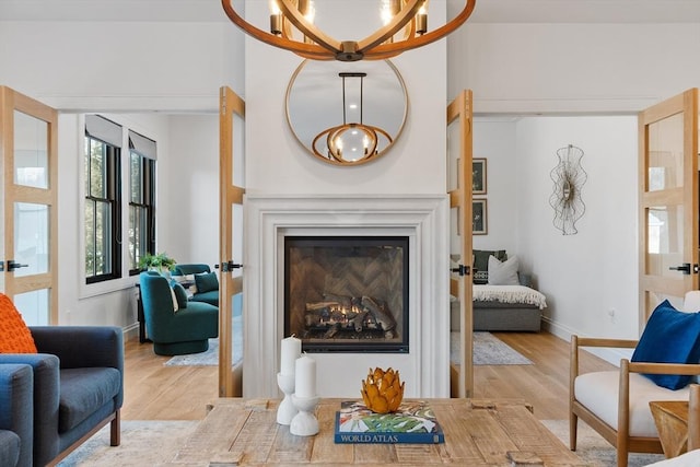 living room with light hardwood / wood-style flooring and a chandelier