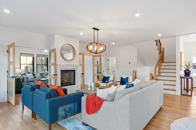 living room featuring an inviting chandelier and light hardwood / wood-style flooring