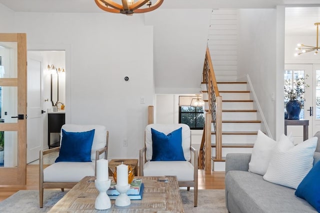 living room with a notable chandelier and light hardwood / wood-style floors