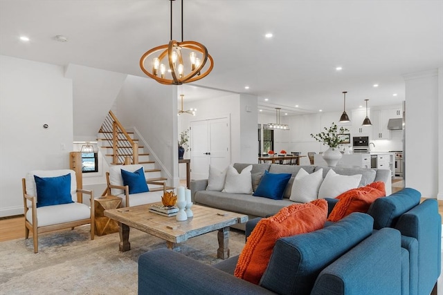 living room with light wood-type flooring and an inviting chandelier