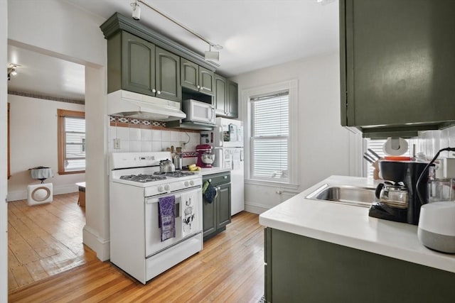 46 Hunting St, Somerville, MA 02143 - kitchen with white appliances, green cabinetry, under cabinet range hood, and light wood-style flooring