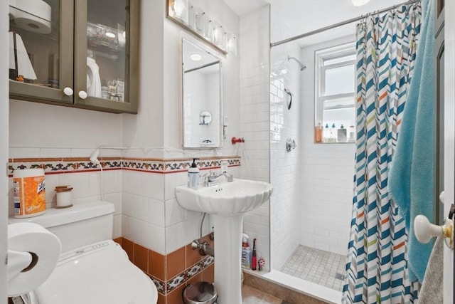 46 Hunting St, Somerville, MA 02143 - bathroom with tile walls, a tile shower, toilet, and wainscoting