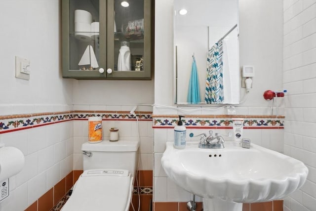 46 Hunting St, Somerville, MA 02143 - full bathroom with tile walls, toilet, wainscoting, a shower with shower curtain, and a sink