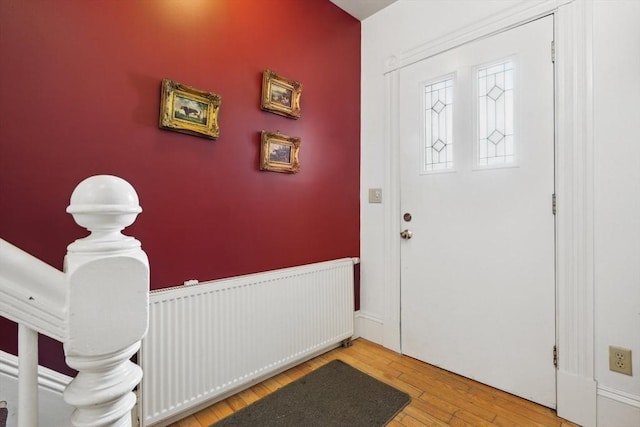 46 Hunting St, Somerville, MA 02143 - entrance foyer featuring radiator and wood finished floors
