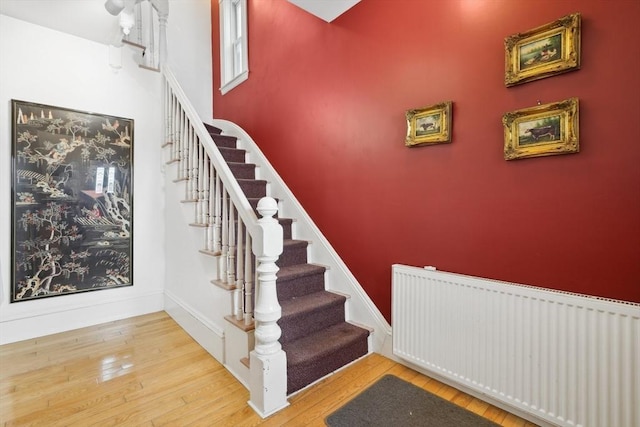 46 Hunting St, Somerville, MA 02143 - staircase with radiator and hardwood / wood-style flooring