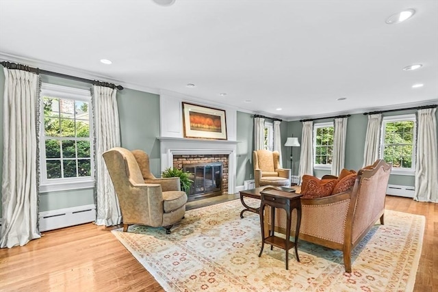 21 Fernway, Winchester, MA 01890 - living area featuring a baseboard radiator, ornamental molding, light wood-type flooring, a fireplace, and plenty of natural light