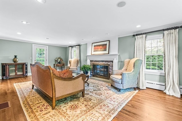 21 Fernway, Winchester, MA 01890 - living area featuring crown molding, a brick fireplace, recessed lighting, wood finished floors, and baseboards