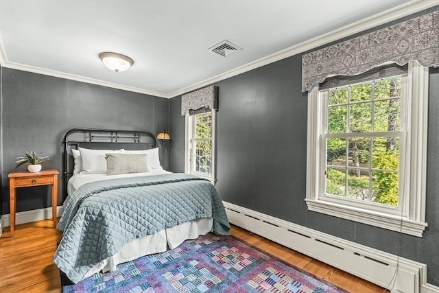 21 Fernway, Winchester, MA 01890 - bedroom with a baseboard radiator, multiple windows, ornamental molding, wood finished floors, and baseboards