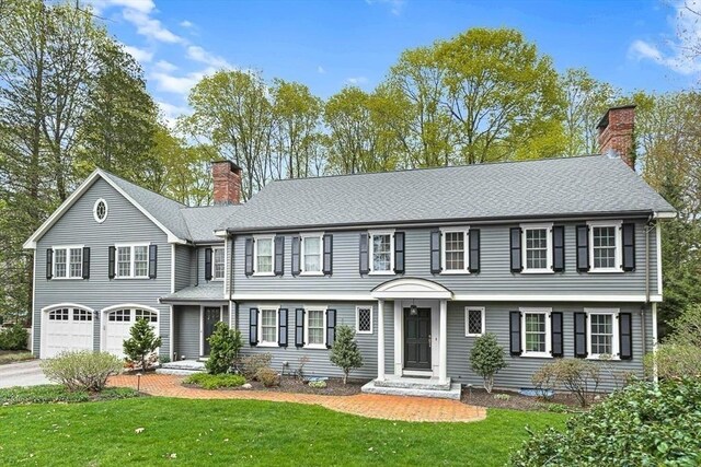 21 Fernway, Winchester, MA 01890 - colonial-style house with a chimney, a garage, a front yard, and concrete driveway