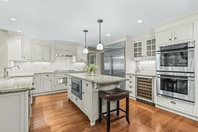 21 Fernway, Winchester, MA 01890 - kitchen with built in appliances, wine cooler, a sink, decorative backsplash, and light stone counters