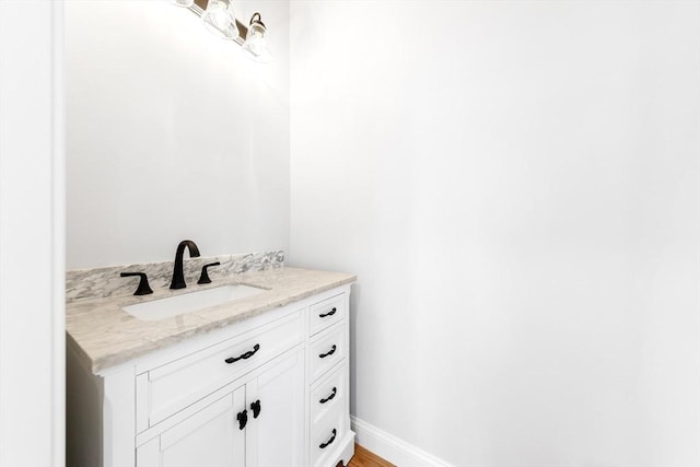 bathroom with vanity and baseboards