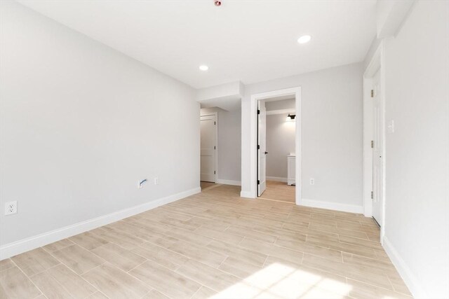 unfurnished bedroom with wood finish floors, baseboards, and recessed lighting