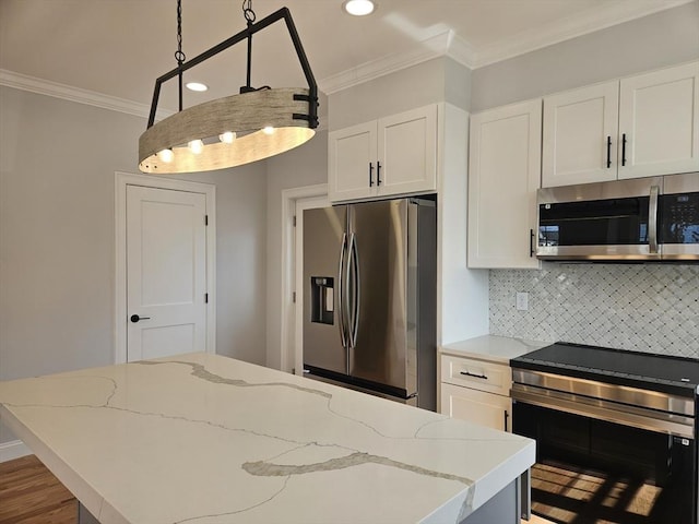 kitchen with stainless steel appliances, hanging light fixtures, backsplash, ornamental molding, and white cabinets