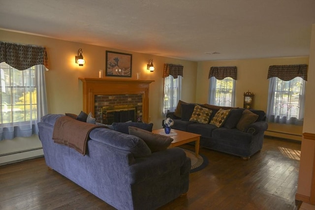 living room with a baseboard radiator, a brick fireplace, and wood finished floors