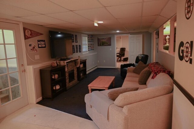 living room featuring dark carpet, a paneled ceiling, and baseboard heating