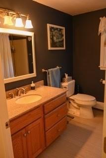 full bath featuring vanity and toilet