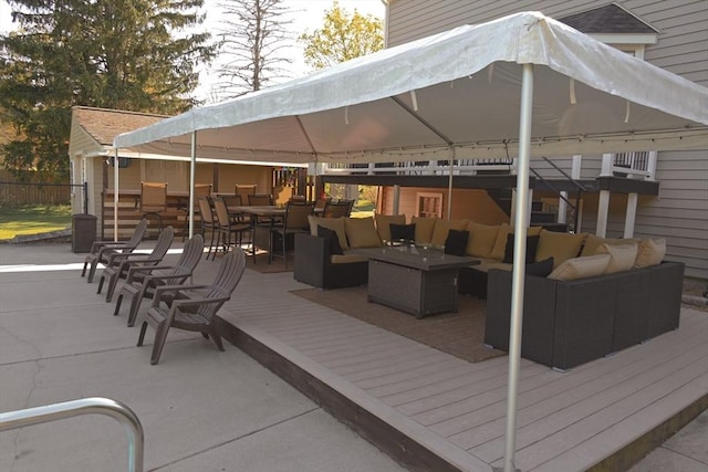 view of patio featuring an outdoor living space, outdoor dining space, a deck, and a gazebo
