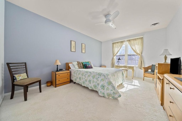 bedroom with light carpet, baseboards, visible vents, and a ceiling fan