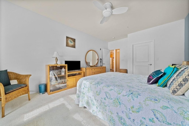 bedroom with a ceiling fan and light carpet