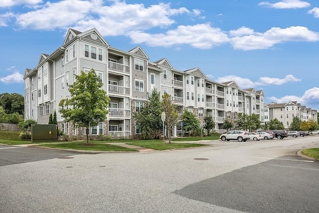 view of building exterior with uncovered parking