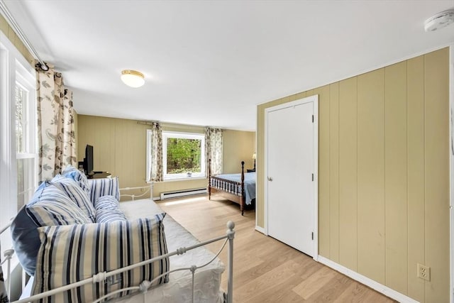 bedroom featuring a baseboard radiator and light wood-style floors