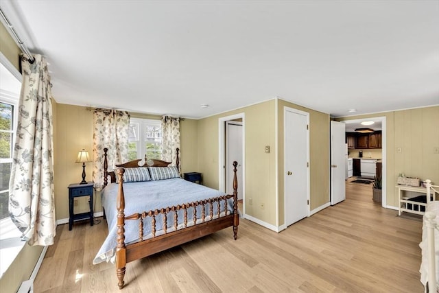 bedroom featuring light wood-style flooring and baseboards