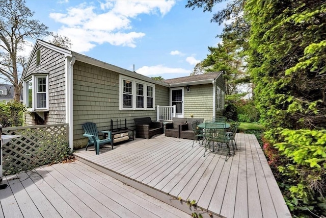 deck with an outdoor living space and outdoor dining area