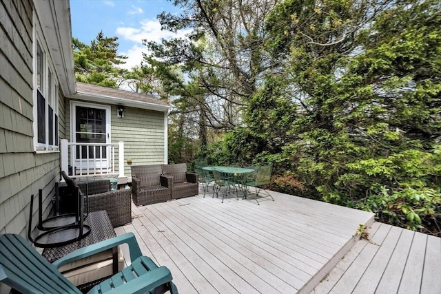 wooden terrace featuring outdoor dining area and an outdoor living space